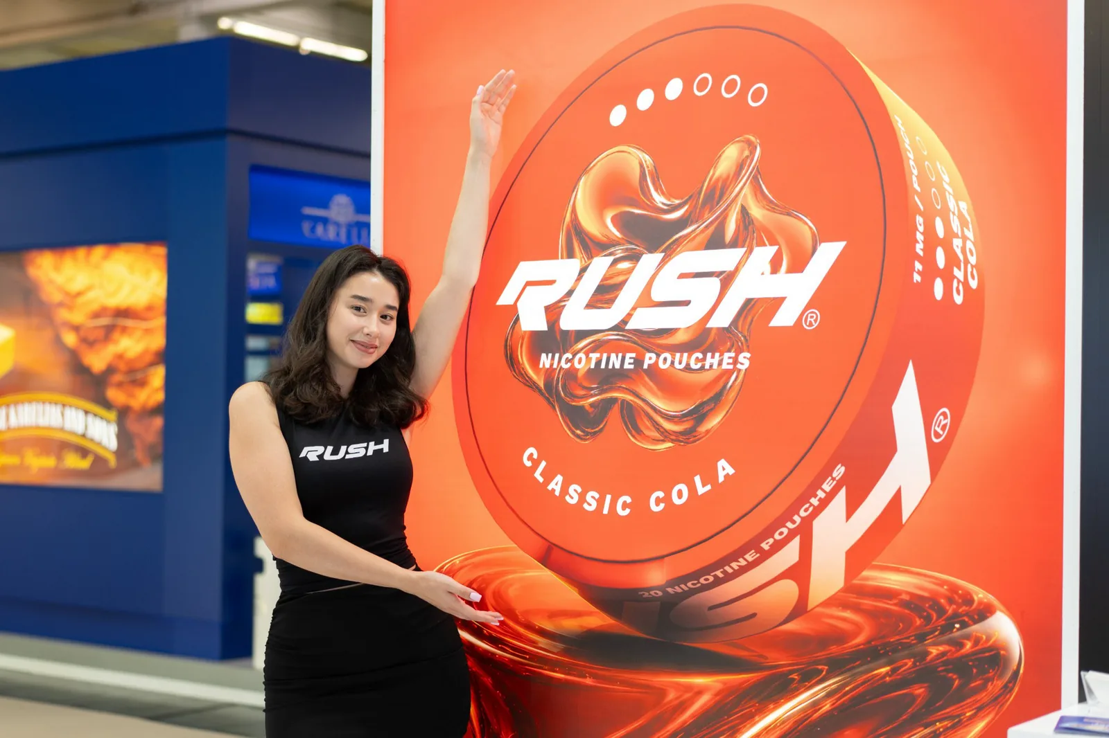 Hostess in front of the Rush stand graphic at InterTabac 2026