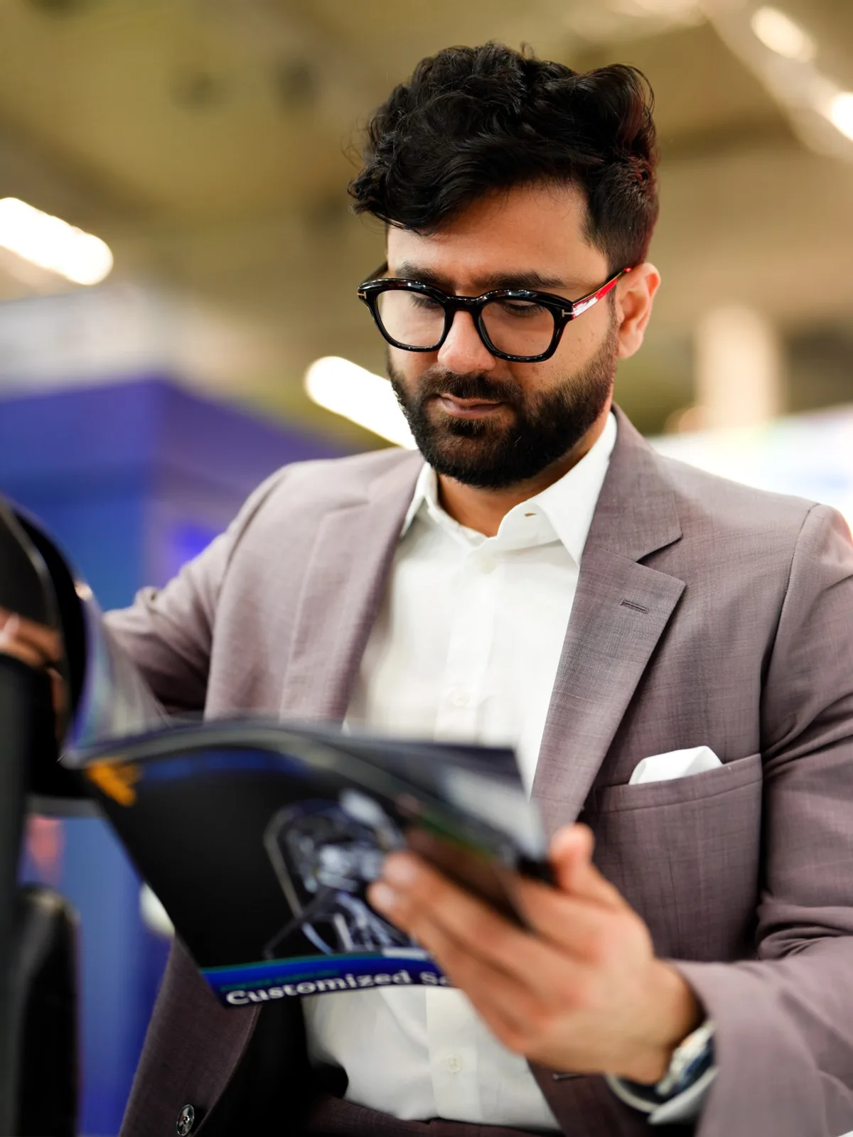 Visitor reading a brochure on the stand, InterTabac 2026